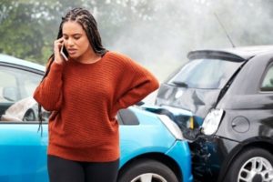 Woman calling lawyer after rear-end accident.